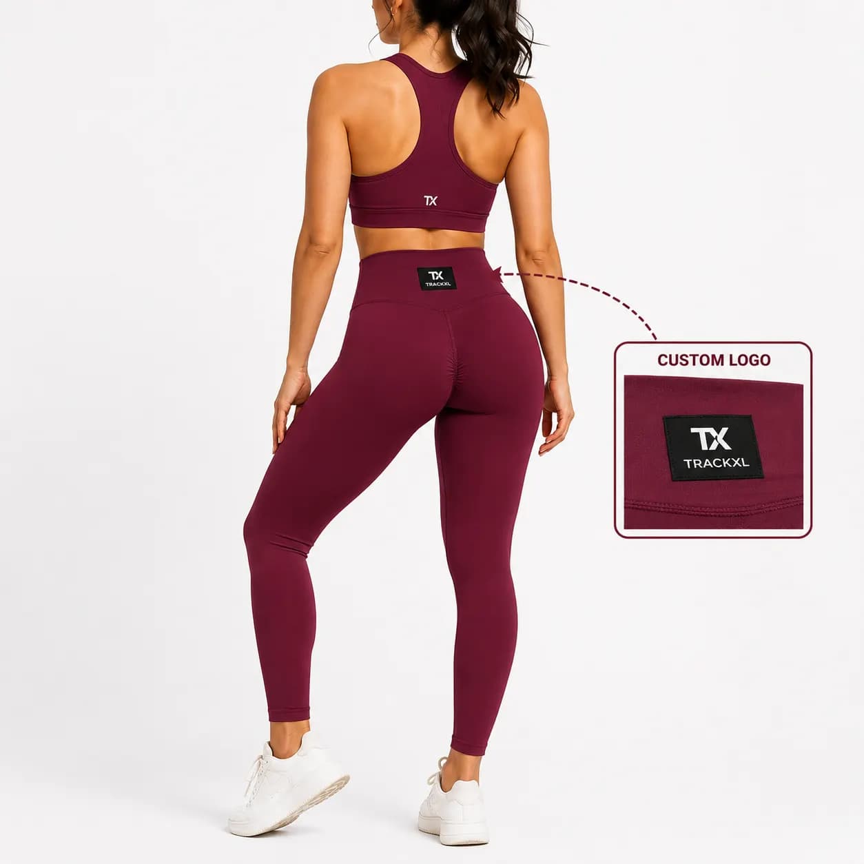 Women's burgundy matching gym set featuring a high-waist seamless legging and supportive sports bra with custom woven logo tag for OEM private label activewear manufacturing.