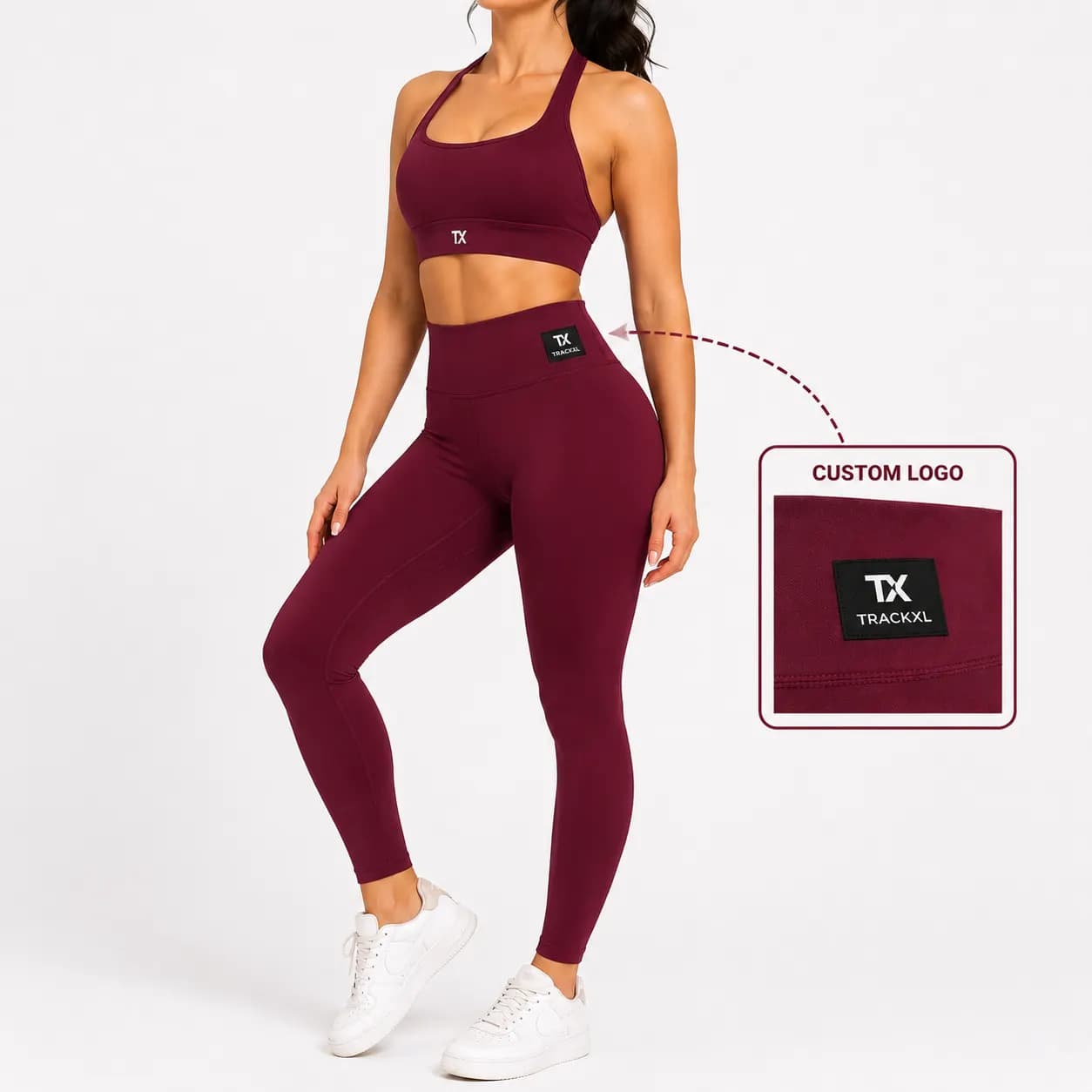 Women's burgundy matching gym set featuring a high-waist seamless legging and supportive sports bra with custom woven logo tag for OEM private label activewear manufacturing.